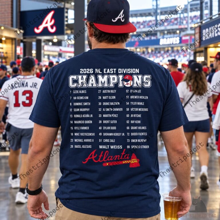 Fan wearing a 2026 NL East Division Champions Atlanta baseball t-shirt at a stadium.