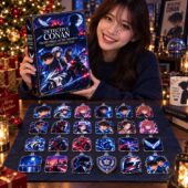 Woman holding a Detective Conan Fallen Angel of the Highway 2026 advent calendar with character ornaments on a display board.
