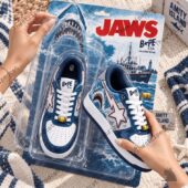 A pair of BAPE STA Jaws collector edition sneakers in blister packaging held by hand.
