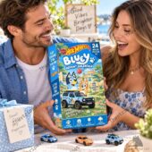 A couple holding a Hot Wheels Bluey Advent Calendar with miniature cars on the table.