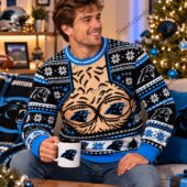 Man wearing a Carolina Panthers festive holiday sweater with team logos and patterns.