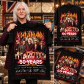Joe Elliott holding a black Def Leppard 50th anniversary shirt