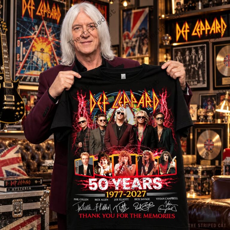 Joe Elliott holding a Def Leppard 50 Years 1977-2027 commemorative t-shirt