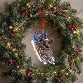Godzilla and Kong Christmas ornament hanging on a wreath