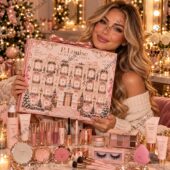 A woman holding a P.Louise advent calendar surrounded by beauty products from TheStripedcat.