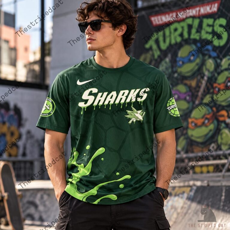 Man wearing a green Teenage Mutant Ninja Turtles and Sharks themed t-shirt