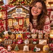 Toll House Advent Calendar 2026 24 Day Surprises 2 Woman smiling behind a Toll House 2026 advent calendar with miniature baking-themed ornaments.