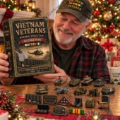 A smiling veteran holding a Vietnam Veterans Memorial Collection box set at TheStripedcat.